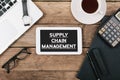 Text supply chain management on screen of table computer at office desk Royalty Free Stock Photo